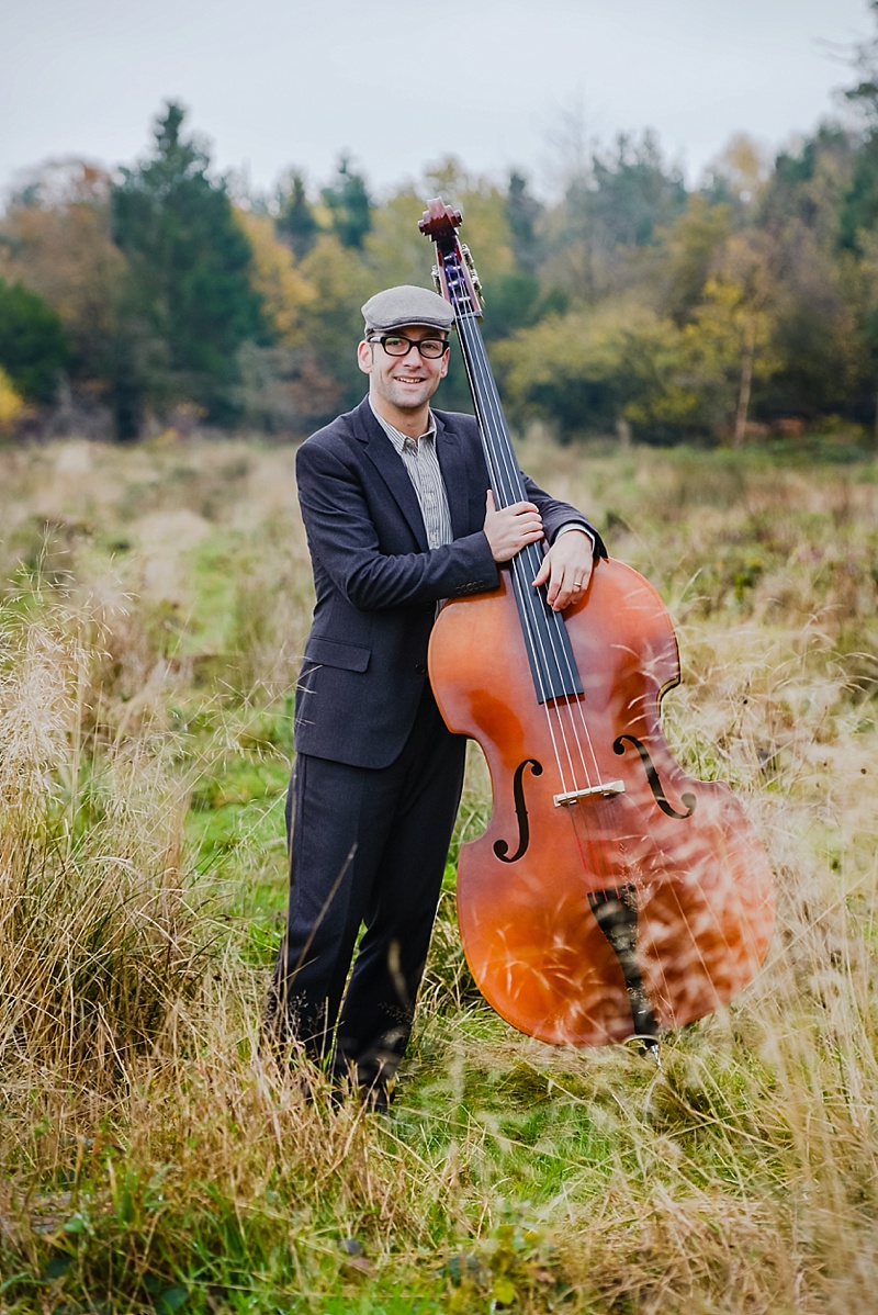 Musician standing in field with cello on portrait photoshoot in Shrewsbury with Victoria La Bouchardiere