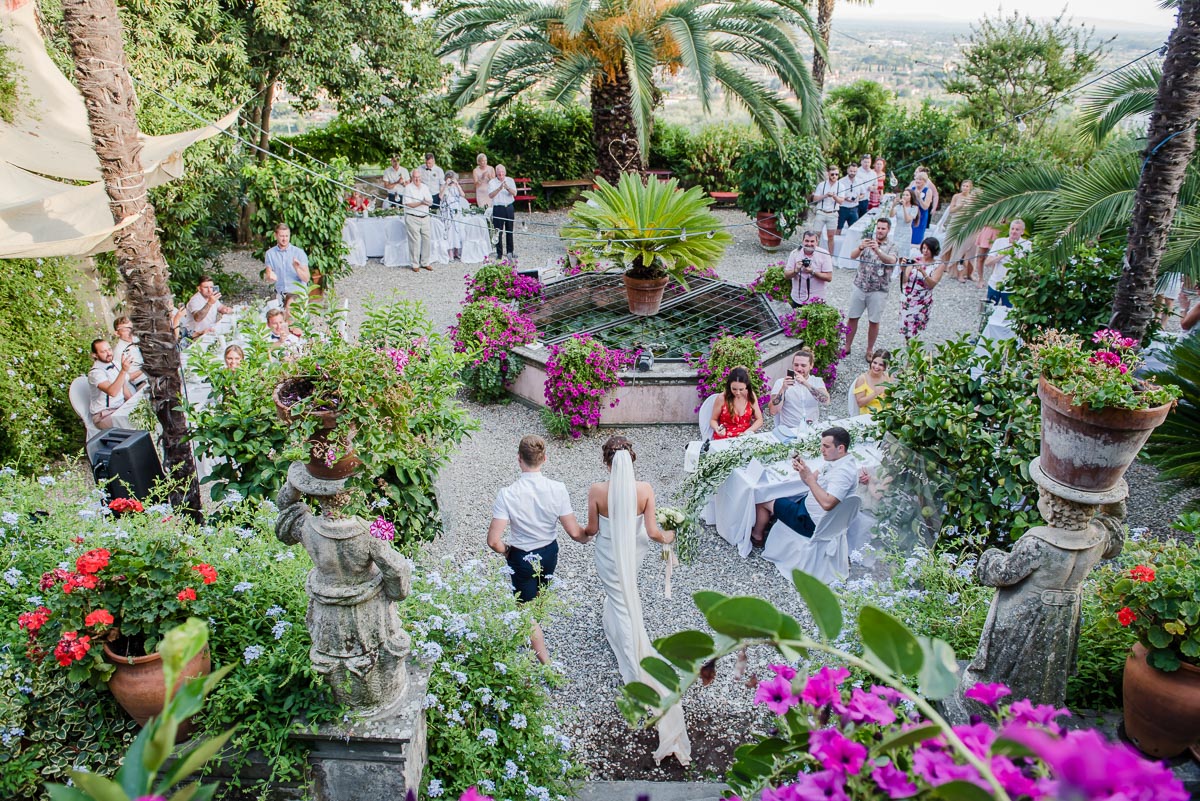 bride and groom welcomed by guests at reception in Tuscany Italy taken by Victoria La Bouchardiere