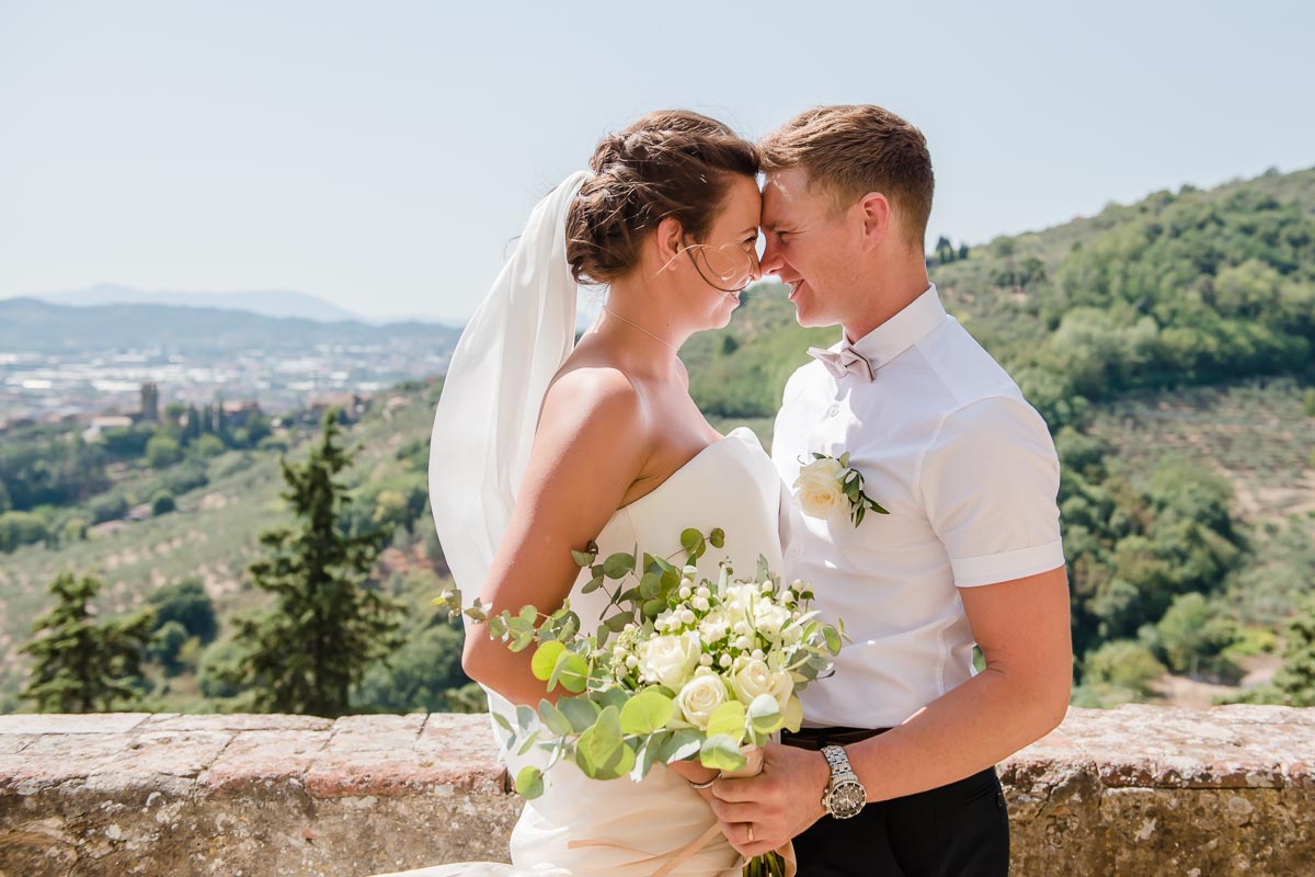 Couple in Tuscany Italy overlooking landscape at Wedding taken by Victoria La Bouchardiere