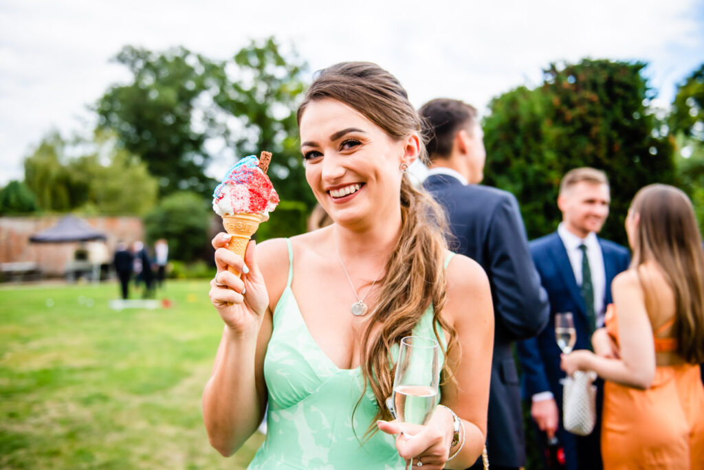 woman in green dress with icecream at wedding