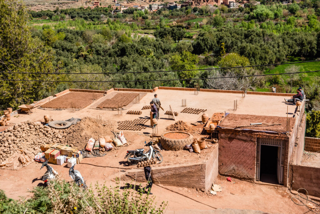 Moroccon men working on a rooftop making clay items