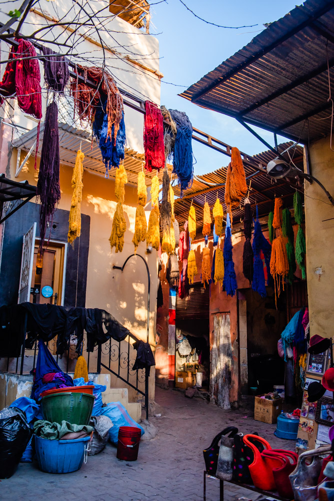 red blue and yellow wool hanging to dry after bring dyed in Marrakesh Souk