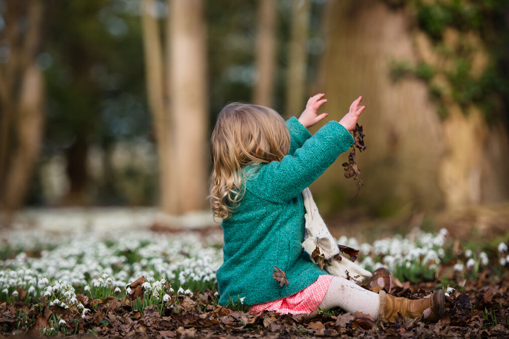 girl in snowdrops wearing green jumper at Attingham on photoshoot with Victoria La Bouchardiere
