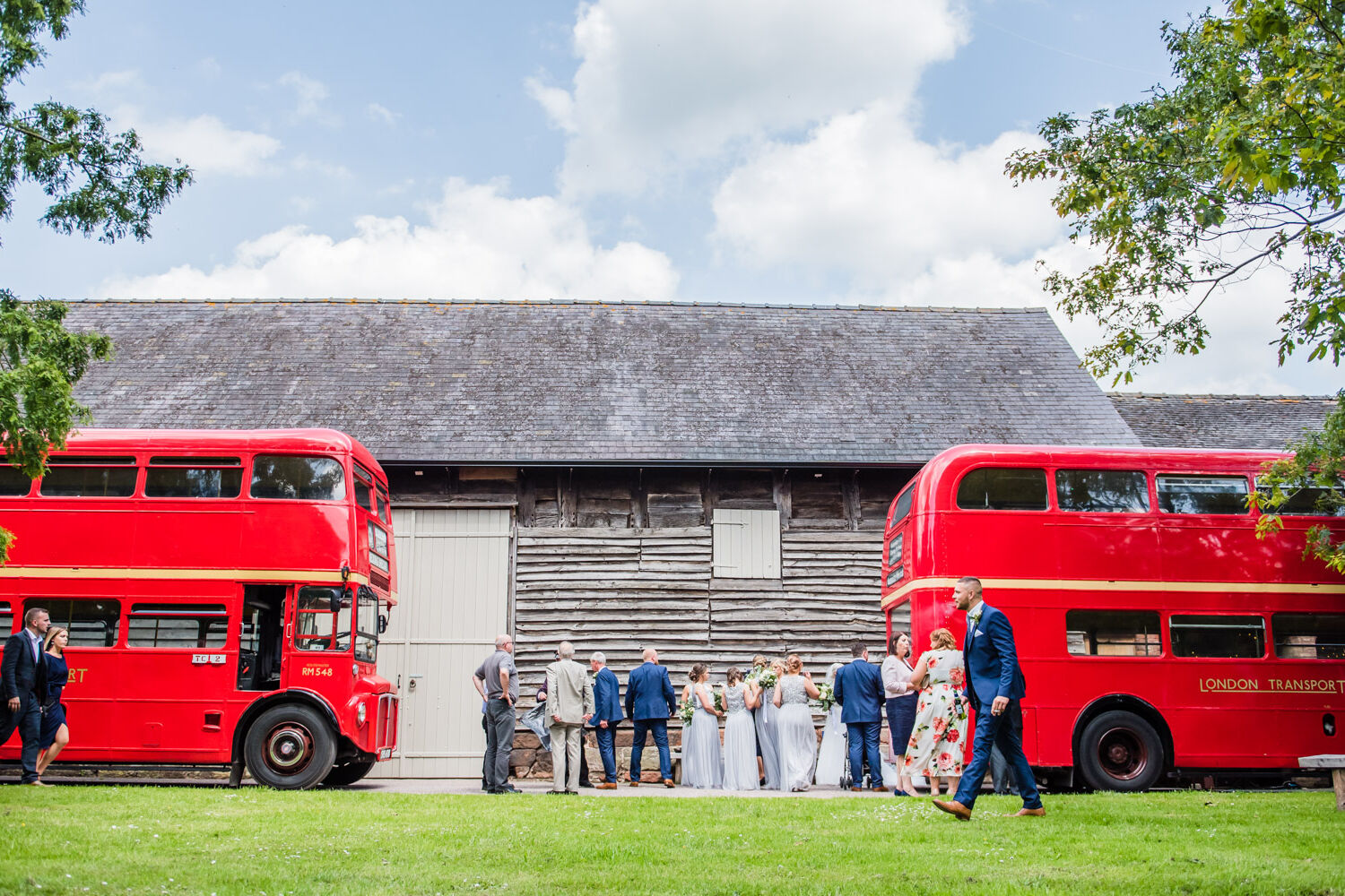 red double decker buses at Pimhill Barn taken by Shrewsbury wedding photographer Victoria La Bouchardiere